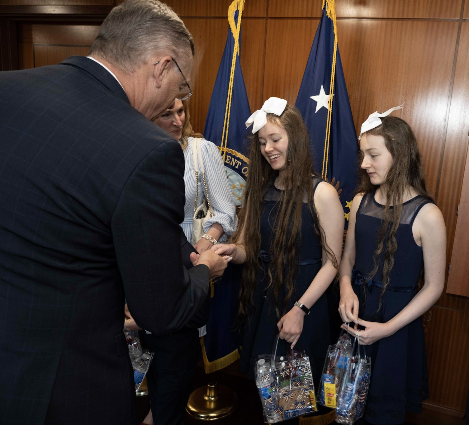 Students presenting a gracious gift at a formal Northern Virginia event