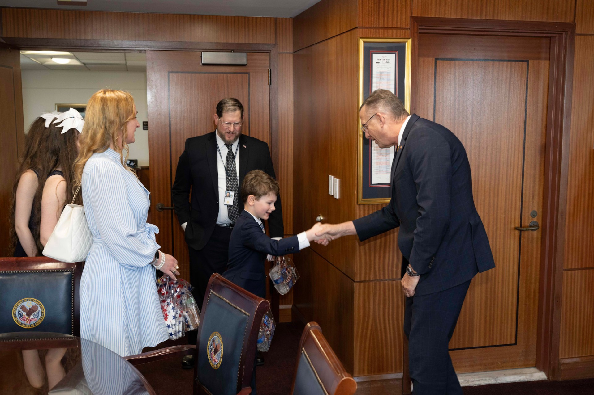 A Northern Virginia cotillion student greeting a guest with a confident handshake